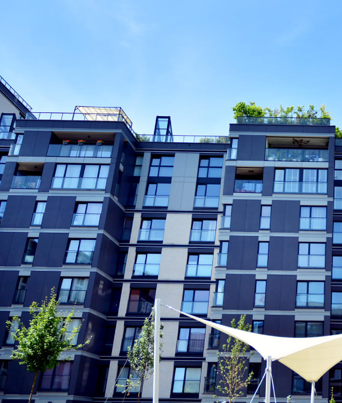 Modern apartment building with glass and blue sky