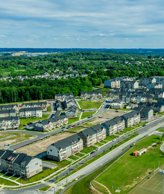 Aerial view of tree-filled housing development